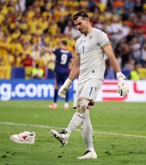MUNICH, GERMANY - JULY 02: Florin Nita of Romania kicks a trainer off of the pitch after a pitch invader is removed during the UEFA EURO 2024 round of 16 match between Romania and Netherlands at Munich Football Arena on July 02, 2024 in Munich, Germany. (Photo by Carl Recine/Getty Images)