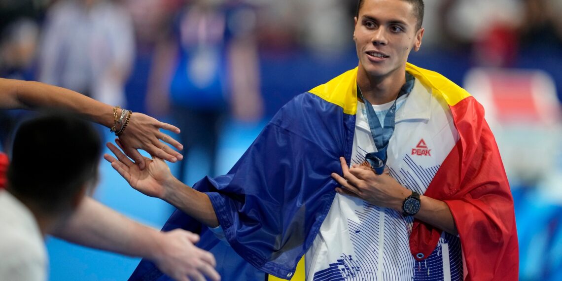 Bronze medalist David Popovici, of Romania, greets fans after the men's 100-meter freestyle final at the 2024 Summer Olympics, Wednesday, July 31, 2024, in Nanterre, France.,Image: 894712180, License: Rights-managed, Restrictions: This content is intended for editorial use only. For other uses, additional clearances may be required., Model Release: no, Pictured: David Popovici