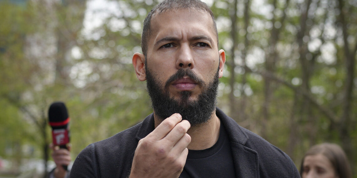 Andrew Tate touches his beard after leaving the Bucharest Tribunal, in Bucharest, Romania, Friday, April 21, 2023. The brothers' attendance on Friday comes after they won an appeal on March 31 to be moved from police custody to house arrest, where they will remain until at least April 29. (AP Photo/Vadim Ghirda)