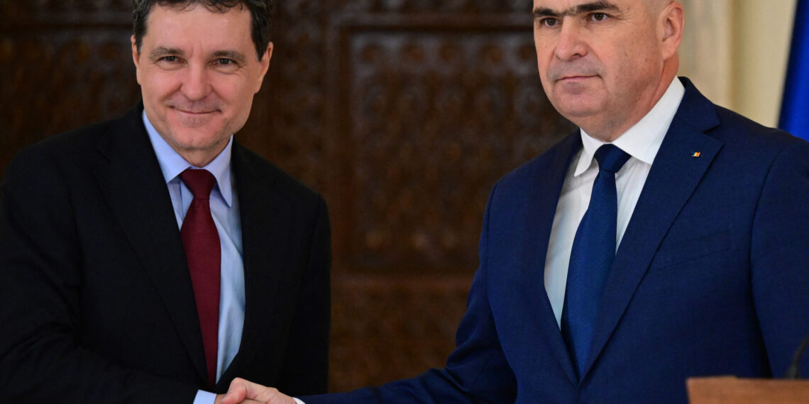 Romanian President Nicusor Dan (L) and designated Prime Minister Ilie Bolojan (R) shake hands a joint press statement at Cotroceni Palace, the Romanian Presidency's headquarters, in Bucharest June 20, 2025. Romanian President Nicusor Dan named liberal politician Ilie Bolojan as prime minister on June 20, 2025, following weeks of negotiations aimed at appointing a new government and ending months of political turmoil.
The 56-year-old will be tasked with tackling Romania's dire finances and reconciling the divided country. (Photo by Daniel MIHAILESCU / AFP)